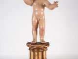 an image of a statue of a child on a pedestal