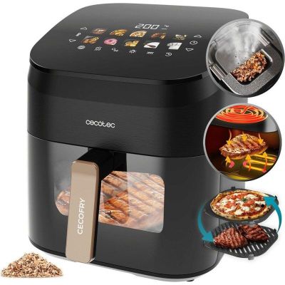 un gros plan sur une friteuse à air chaud noire contenant tout un tas d'aliments
