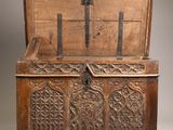 an old wooden chest with ornate carvings on the front
