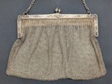 an antique silver mesh purse with chain handles