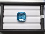 a blue diamond in a black box on a table