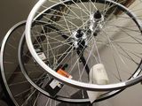 a bicycle wheel hanging from the ceiling in a garage