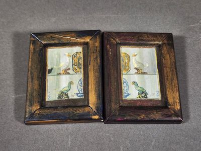 deux cadres photo ornés d'oiseaux, posés sur une table