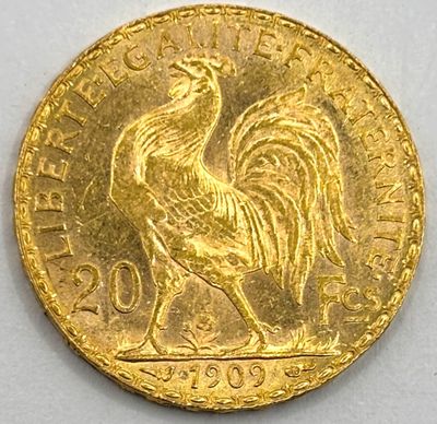 a close up of a gold coin with a rooster on it