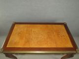 an antique style coffee table with a wooden top and brass trim