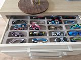 a drawer that has many pairs of glasses in it