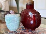 two vases sitting on a glass table next to each other