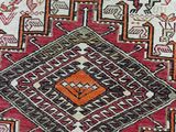 a close up of a red and white rug with a design on it