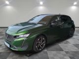 the green car is parked on a checkered floor in a room