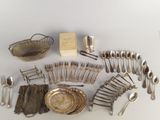 a lot of silverware and silverware on a table