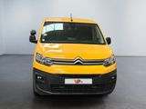 the yellow van is parked in a white room with a black floor