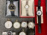a lot of watches in a box on the floor