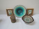 several pieces of art are displayed on a table with pictures