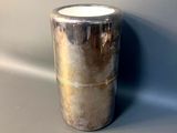 a silver vase sitting on a table with a gray background