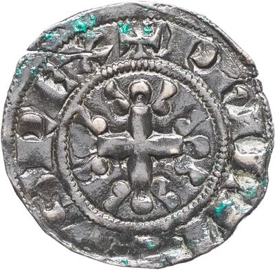 une vieille pièce d'argent ornée d'une croix