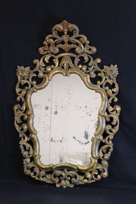 an ornately decorated mirror on a black background with a black background