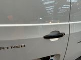 a white car with a chrome emblem on the door