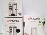 three boxes of brabantia trash cans sitting on top of a table