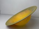 a yellow bowl that is sitting on a counter