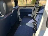 a seat in the back of a van that is blue and white