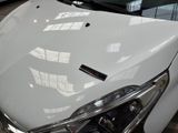 a close up of a white car in a showroom
