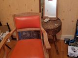 a chair and a mirror in the corner of a room