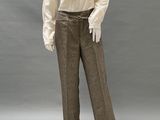 a mannequin of a man wearing a white shirt and brown pants