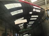 a reflection of a car in the rear window of a vehicle