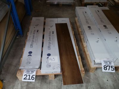 Plusieurs caisses en bois sont empilées sur des palettes dans un entrepôt