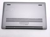 a silver laptop with a black keyboard on a white surface