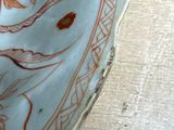 a close up of a plate with a design on it