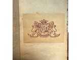 a picture of an old book with a picture of a coat of arms on it