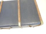 an old suitcase sitting on top of a white table
