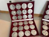 two red cases with silver coins in them on a table