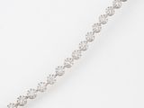 a close up of a diamond bracelet on a white background