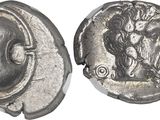 a close up of a silver coin with a face on it
