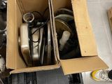a cardboard box full of assorted items on the floor
