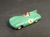a green toy car with a red helmet on it