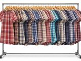 clothes hanging on a clothes rack on a white background