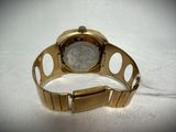 a close up of a watch on a white surface