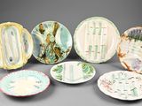 several plates with different designs and designs on them on a gray surface