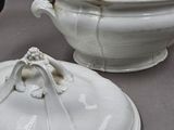 two white dishes sitting on a table next to each other