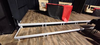 a stage set up with a red and black curtain