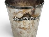 a silver cup with a handle on a white background