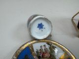 a blue and white plate with a gold border and a blue and white plate with a star of david on it