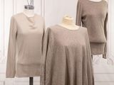 two women ' s sweaters on a mannequin stand in front of a white wall