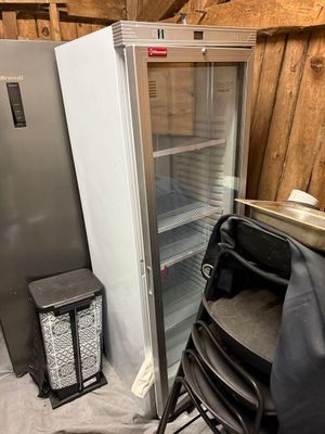 an image of a refrigerator and a chair in a room