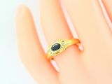 an image of a gold ring with a blue stone on it