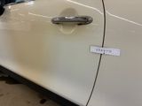 a close up of a car door handle with a sticker on it