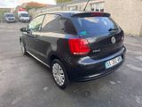 the back of a black volkswagen polo parked in a parking lot